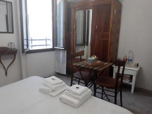 a room with a bed and a table and chairs at Come una volta in Monte Isola