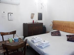 a bedroom with a bed and a table with towels on it at Come una volta in Monte Isola