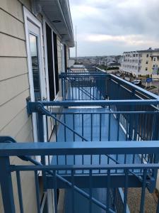 a balcony with blue railing on a building at Misquamicut Beach Front Inn in Misquamicut