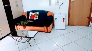 a living room with a chair and a refrigerator at Minha casa pousada in Botucatu +58 photos