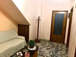 ein Wohnzimmer mit Sofa und Tür in der Unterkunft Regina di denari in Pachino