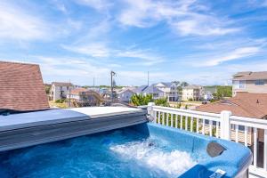 a swimming pool on a balcony with a bed on top at Ocean View's in Kill Devil Hills