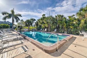 a swimming pool with chaise lounge chairs and a resort at Anna Maria Island Resort Condo with Prime Location! in Bradenton Beach