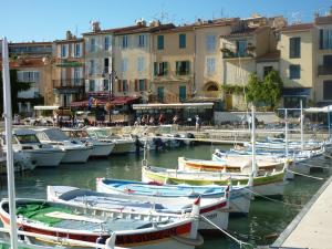 a group of boats docked in a harbor with buildings at ANTINEA in Cassis