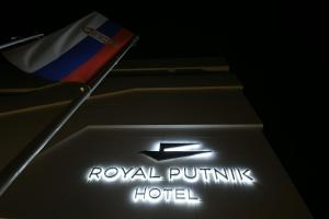 a sign for a royal puffin hotel with a flag at Hotel Royal Putnik in Vranje