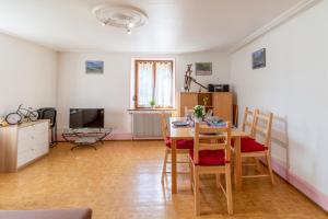 a living room with a table and chairs and a television at Gite le Sotré in Bussang