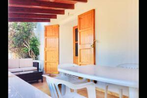 a dining room with a white table and chairs at Casa Rural Es Cap de Barbaria Can Joan Guillem in Sant Francesc Xavier