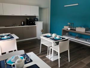 a kitchen and dining room with a table and chairs at B&B Alma Garda Lake in Peschiera del Garda