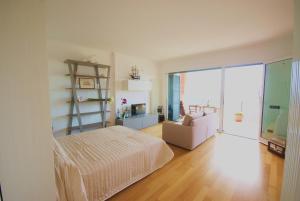 a bedroom with a bed and a living room with a ladder at LOFT BAYVIEW in Imperia