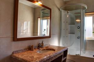 a bathroom with a sink and a shower at Rancho Mar à Vista in Atalaia de Cima +32 photos