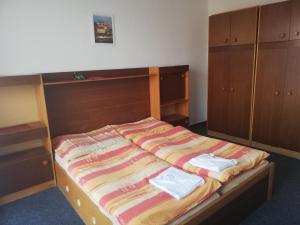 a bedroom with a bed with two towels on it at ABC Hotel Nitra in Nitra