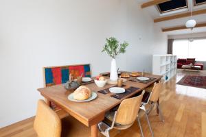 a dining room with a wooden table and chairs at Paris-Maison-appartement-7 chambres métro Jourdain in Paris