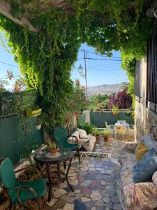 a patio with chairs and a table on a stone patio at Casa al-andalus in Granada