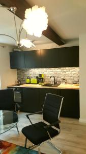 a kitchen with two chairs and a table and a sink at Altstadtapartment an der Krämerbrücke Nr.2 in Erfurt