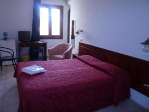 Postel nebo postele na pokoji v ubytování Hotel L'Ancora