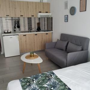 a small living room with a couch and a table at stuDio57 11 in Alexandroupoli