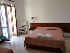 Postel nebo postele na pokoji v ubytování Hotel L'Ancora