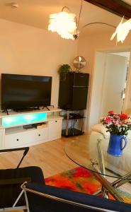a living room with a flat screen tv on a table at Altstadtapartment an der Krämerbrücke Nr.2 in Erfurt +29 photos