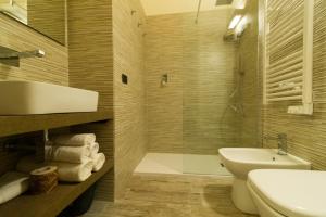 a bathroom with a sink and a toilet and a tub at B&B 49 passi in Fano