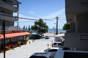 a street with cars parked in a parking lot next to the ocean at Blue Sea Boutique Apartments in Olympic Beach +26 photos