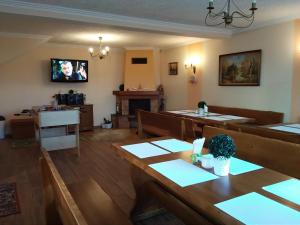 a living room with a table and a tv on the wall at Noclegi Barbara Pietraszek in Krempachy