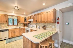 a kitchen with wooden cabinets and a counter top at Walkable Lake Elkhart Apt Dine, Shop, Swim! in Elkhart Lake