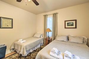 a bedroom with two beds and a window at Walkable Lake Elkhart Apt Dine, Shop, Swim! in Elkhart Lake