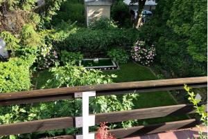 a garden with a wooden fence and flowers at MonikaRooms in Zagreb +22 photos