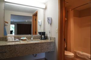 a bathroom with a sink and a phone on the wall at College Inn in Monmouth