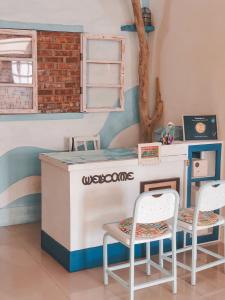 a play kitchen with a table and two chairs at Happiness Factory in Huxi