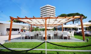 a group of tables and chairs under a pavilion at Torre Del Sole in Terracina
