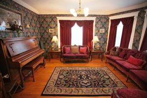 a living room with a piano and a couch at Twin Peaks B&B in Mindemoya