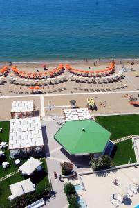an aerial view of a beach with umbrellas and the ocean at Torre Del Sole in Terracina