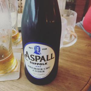 a bottle of beer sitting on a wooden table at KAI Ichinomiya in Ichinomiya