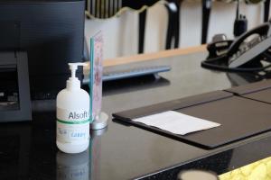 a white bottle of hair lotion sitting on a counter at The Waterfront Hotel Kuching in Kuching