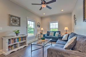 a living room with a couch and a ceiling fan at Airy Apartment with Deck - Walk to Main Street! in Hendersonville