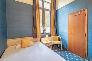 Postel nebo postele na pokoji v ubytování Hotel des Comtes Durbuy