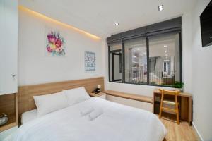 Voodi või voodid majutusasutuse L'amie Hotel & Studio toas +37 fotot