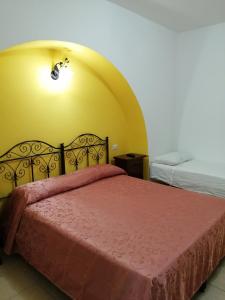 a bedroom with a bed with a red bedspread at Agriturismo Tenuta Perruzzi in Leverano