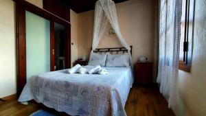 a bedroom with a bed with white sheets and pillows at Varosi Guesthouse in Edessa