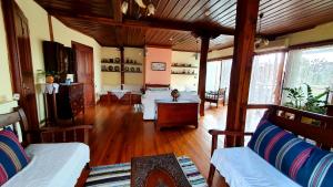 a living room with wooden floors and couches at Varosi Guesthouse in Edessa