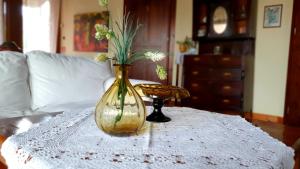 a vase with flowers in it sitting on a table at Varosi Guesthouse in Edessa