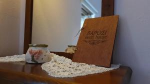 a table with a sign and a vase on it at Varosi Guesthouse in Edessa