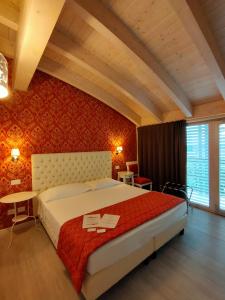 a bedroom with a large bed with a red wall at Nuova Opera Rooms in Verona