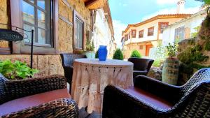 a table with a blue vase sitting on top at Varosi Guesthouse in Edessa