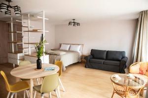a living room with a bed and a table and a couch at NIDA in Nida