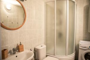 a bathroom with a shower and a toilet and a sink at NIDA in Nida +12 photos