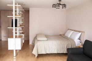 a bedroom with a bed and a living room at NIDA in Nida