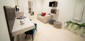 a living room with a white table and a couch at BARI 102 in Bari