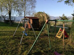 einen Spielplatz mit Schaukel und ein Haus in der Unterkunft Agriturismo Le Spezie in Conegliano